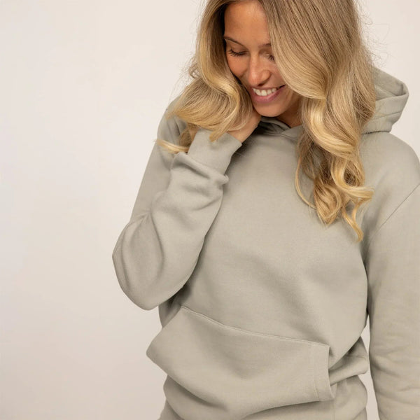 Woman wearing Marame cotton fleece hoodie in Wolf Grey, front view.|wolf green