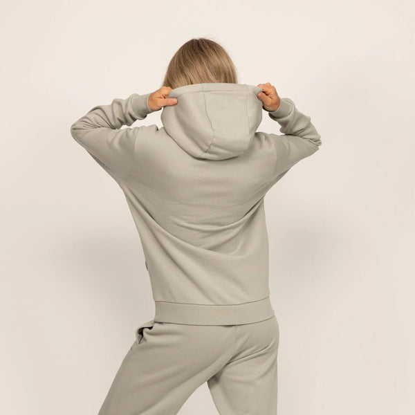 Woman wearing Marame cotton fleece hoodie in Wolf Grey, rear view.|wolf green