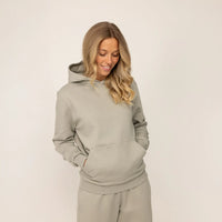 Woman wearing Marame cotton fleece hoodie in Wolf Grey.