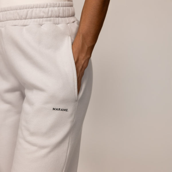 Woman wearing cotton fleece Joggers in Ash White, closeup.