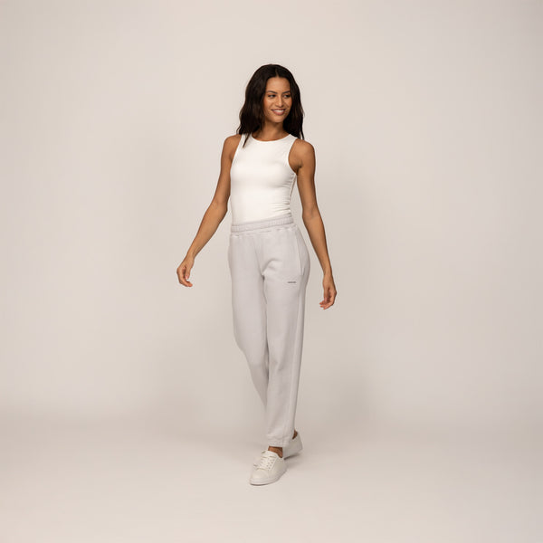 Woman wearing Marame cotton fleece Joggers in Ash White, full view.