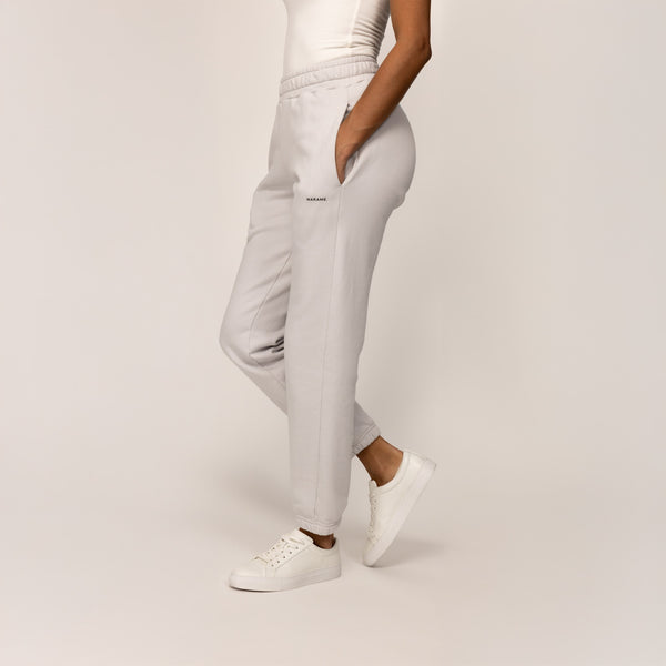 Woman wearing Marame cotton fleece Joggers in Ash White, front view.