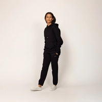 Woman wearing Marame cotton fleece Joggers in Black, full view.|black