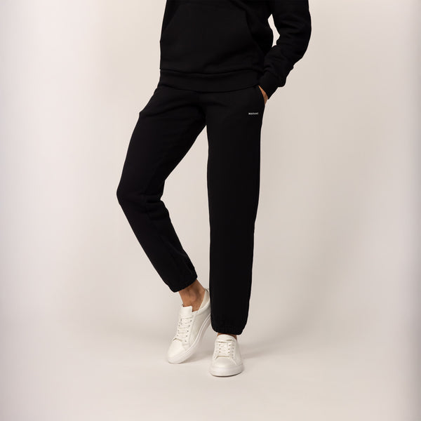 Woman wearing Marame cotton fleece Joggers in Black, front view.