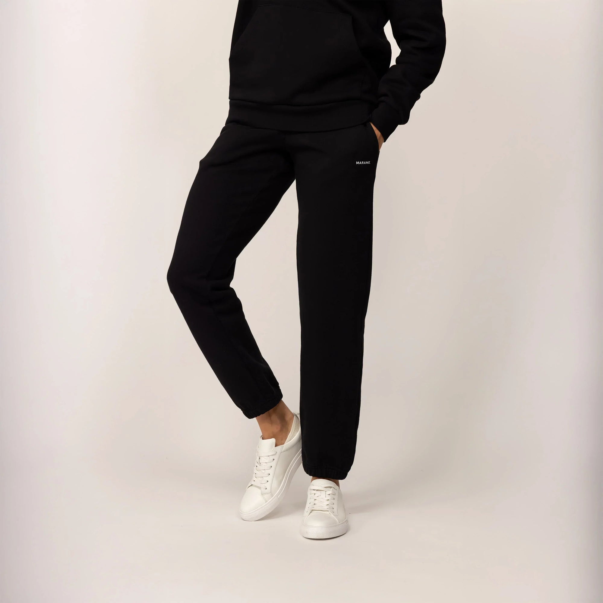 Woman wearing Marame cotton fleece Joggers in Black, front view.|black