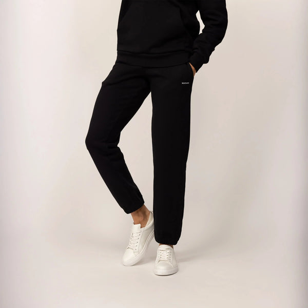 Woman wearing Marame cotton fleece Joggers in Black, front view.|black