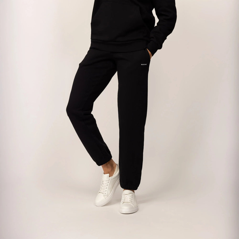 Woman wearing Marame cotton fleece Joggers in Black, front view.|black