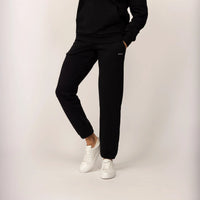 Woman wearing Marame cotton fleece Joggers in Black, front view.|black