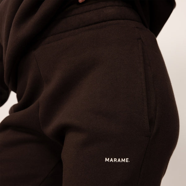 Woman wearing cotton fleece Joggers in Smoked Brown, closeup.
