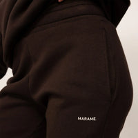 Woman wearing cotton fleece Joggers in Smoked Brown, closeup.