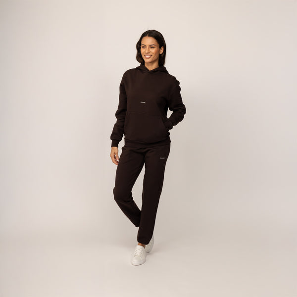 Woman wearing Marame cotton fleece Joggers in Smoked Brown, full view.