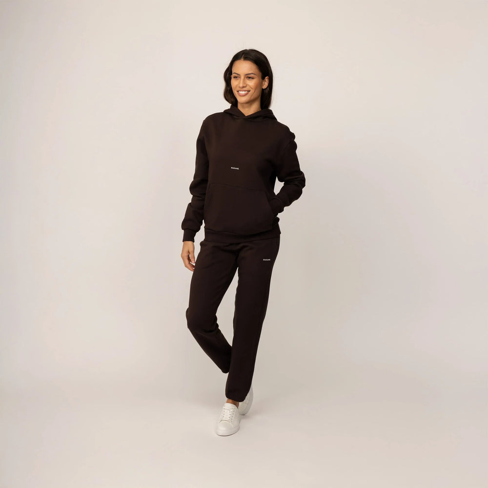 Woman wearing Marame cotton fleece Joggers in Smoked Brown, full view.
