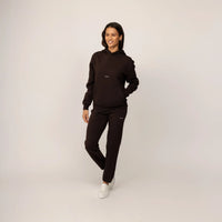 Woman wearing Marame cotton fleece Joggers in Smoked Brown, full view.