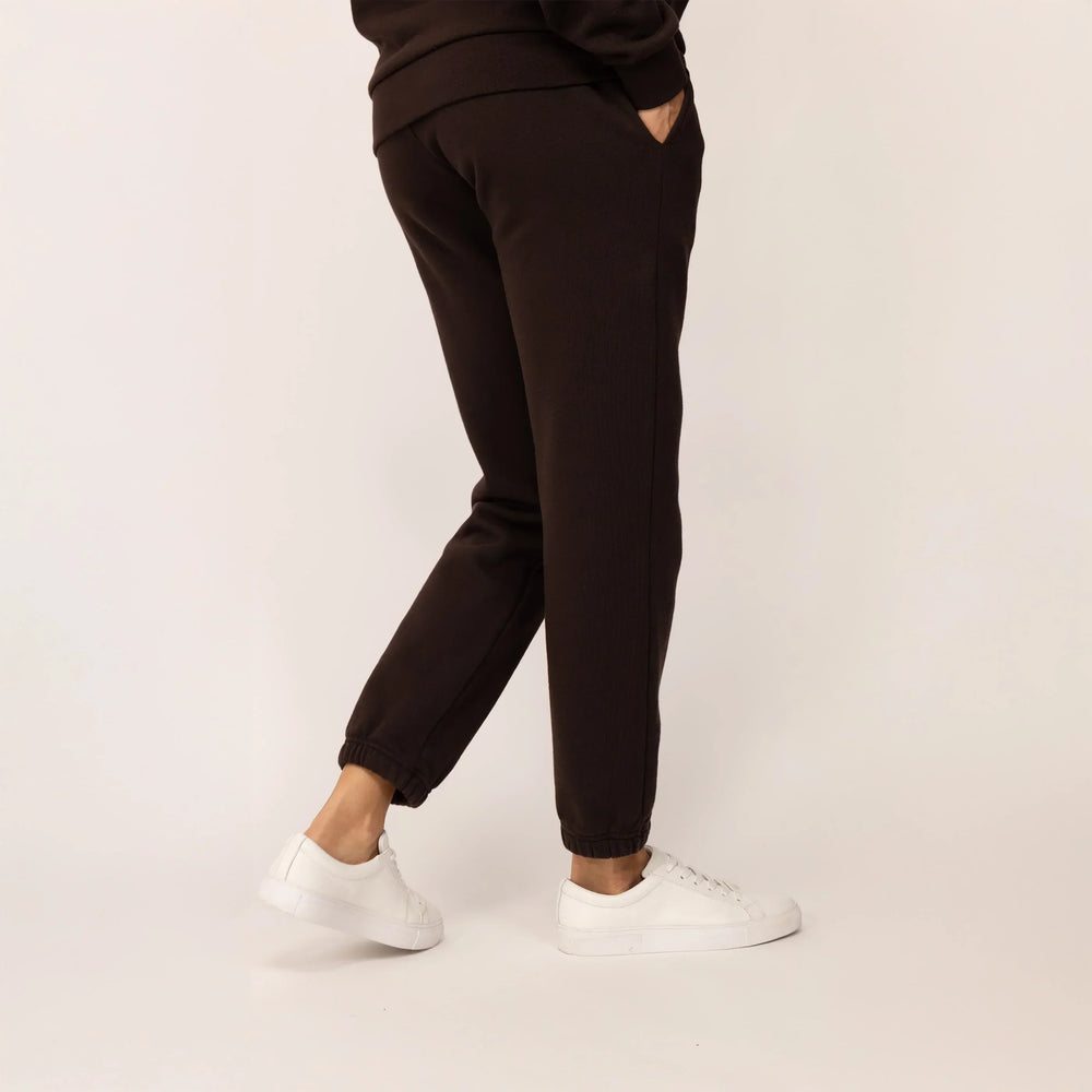 Woman wearing Marame cotton fleece Joggers in Smoked Brown, rear view.