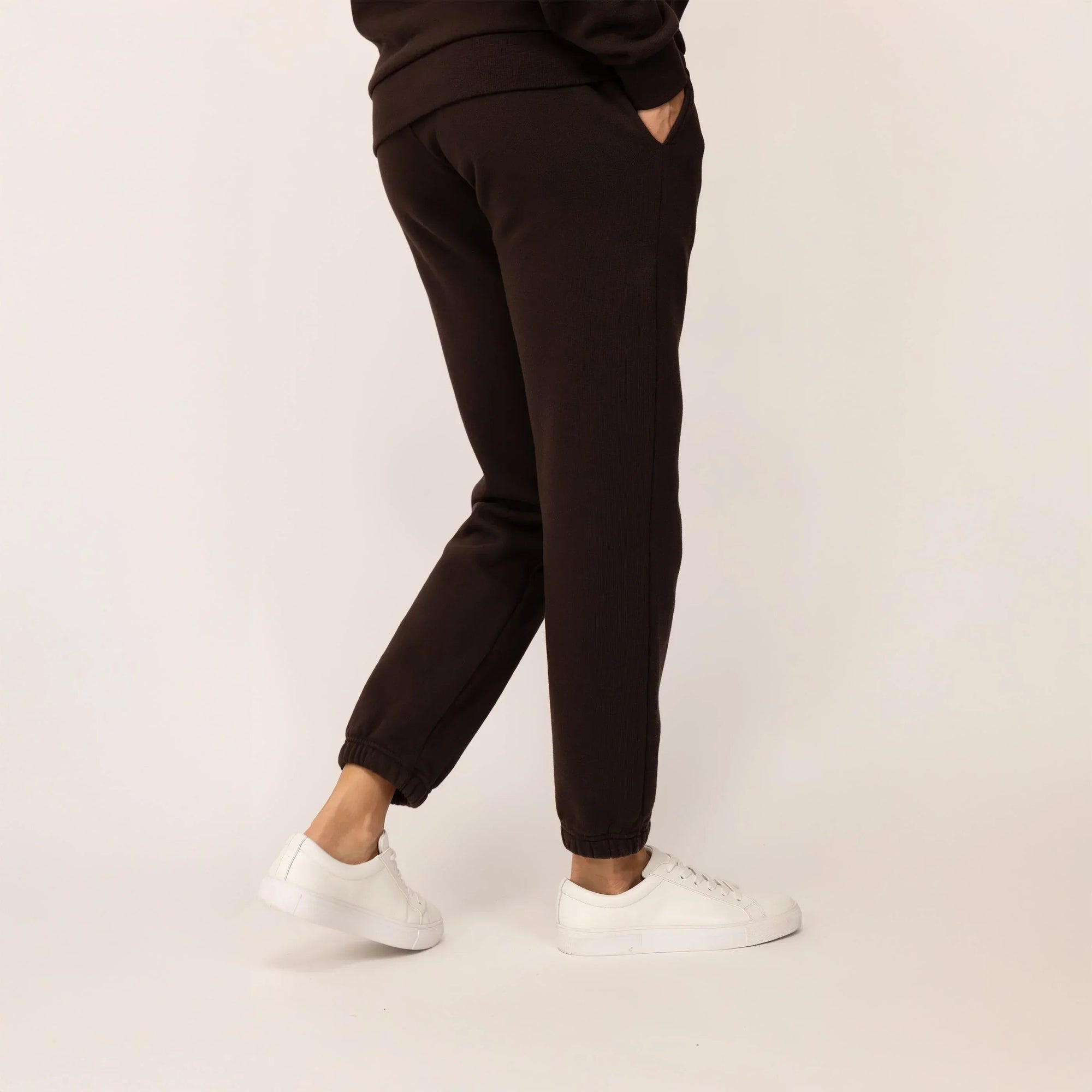 Woman wearing Marame cotton fleece Joggers in Smoked Brown, rear view.|smoked brown