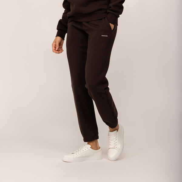 Woman wearing Marame cotton fleece Joggers in Smoked Brown, front view.