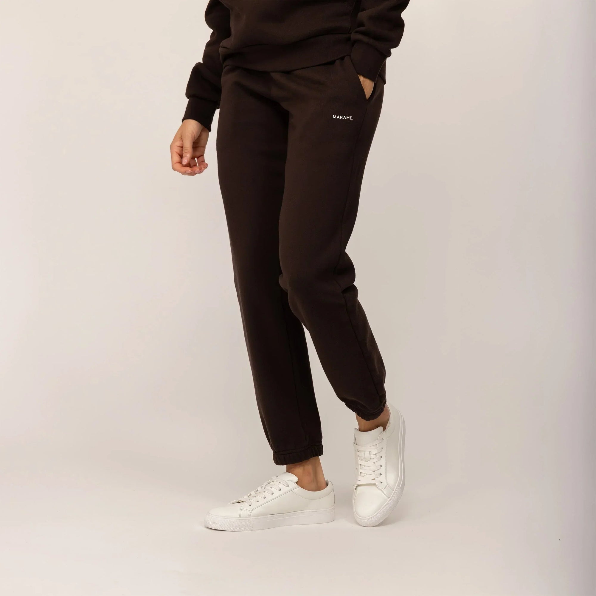 Woman wearing Marame cotton fleece Joggers in Smoked Brown, front view.|smoked brown