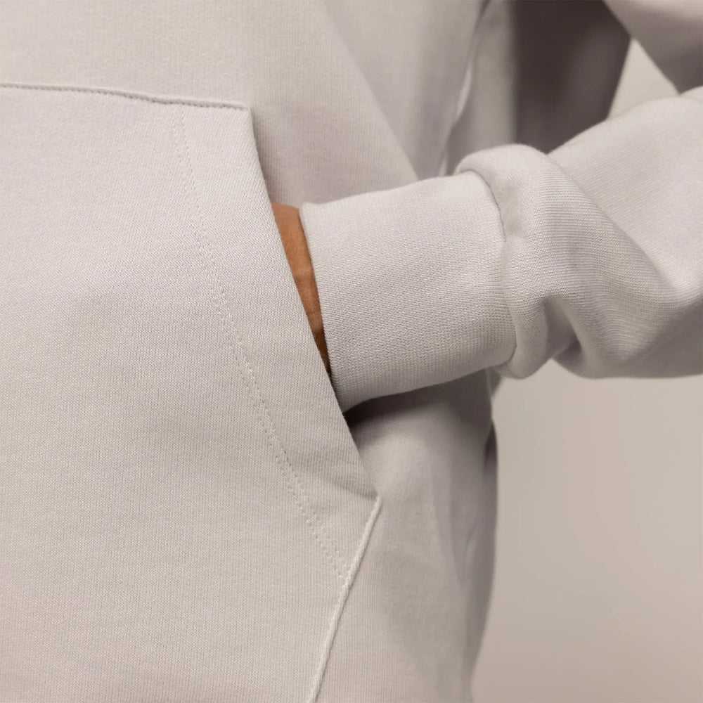 Woman wearing a cotton fleece Logo Hoodie in Ash White, detail.