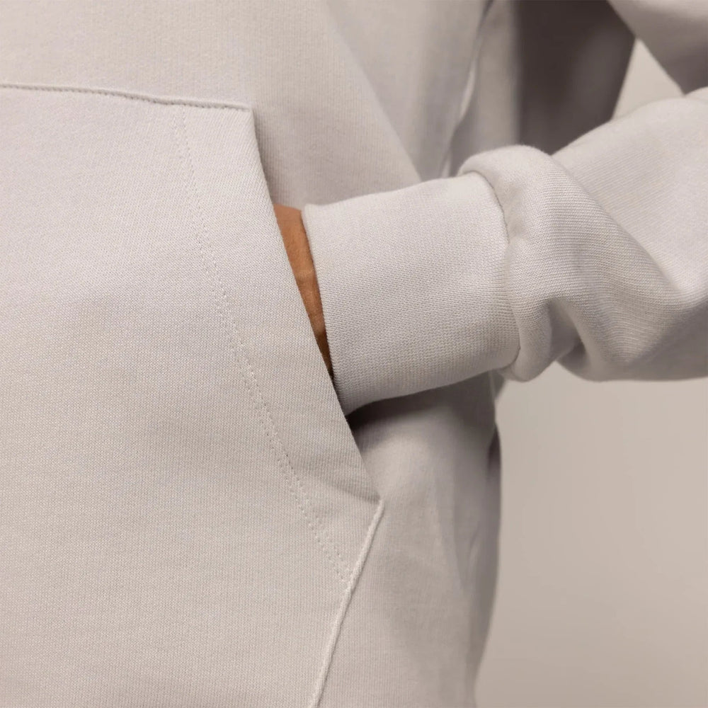 Woman wearing a cotton fleece Logo Hoodie in Ash White, detail.|ash white