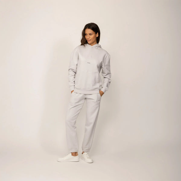 Woman wearing a Marame cotton fleece Logo Hoodie in Ash White, full view.