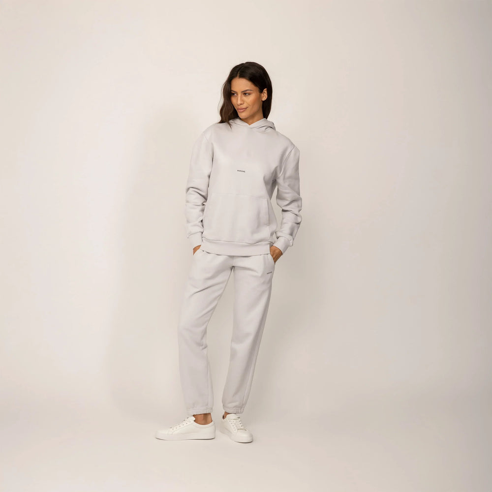 Woman wearing a Marame cotton fleece Logo Hoodie in Ash White, full view.