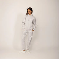 Woman wearing a Marame cotton fleece Logo Hoodie in Ash White, full view.