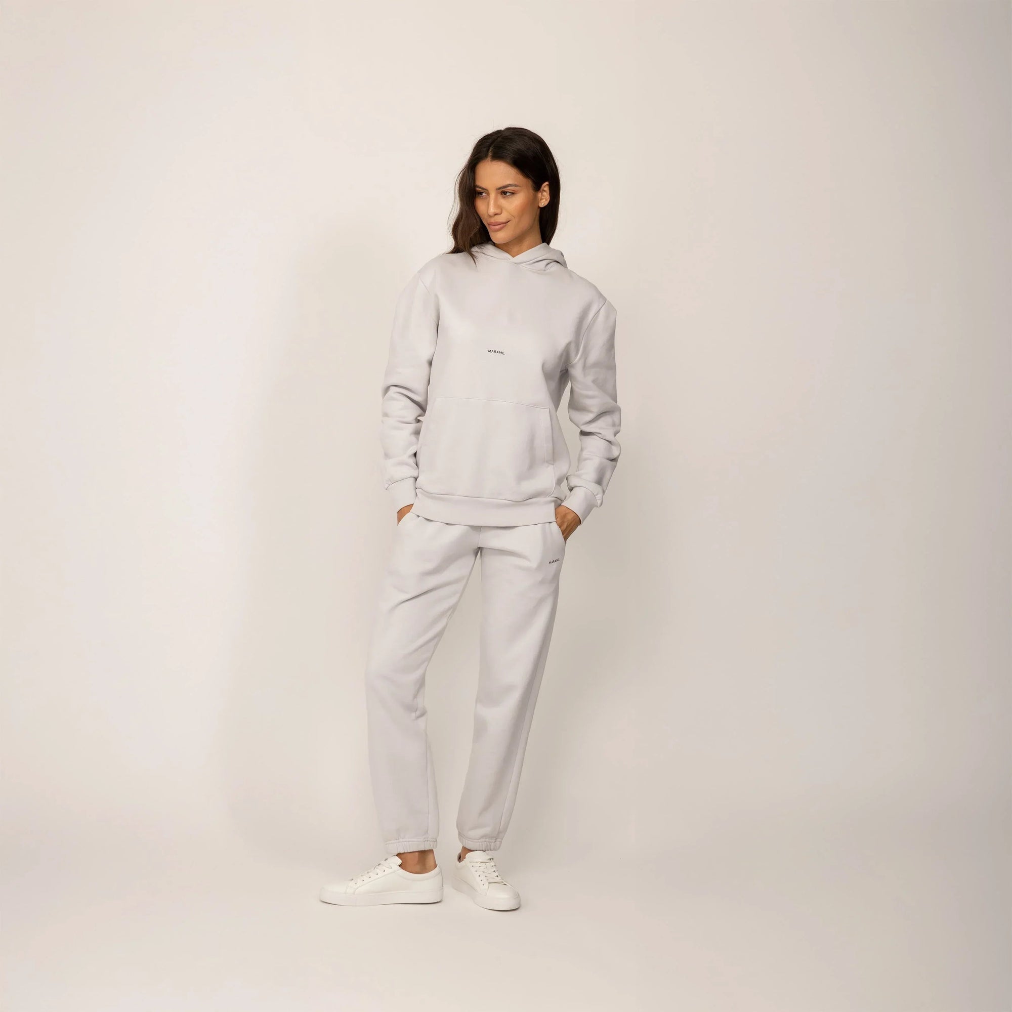 Woman wearing a Marame cotton fleece Logo Hoodie in Ash White, full view.|ash white
