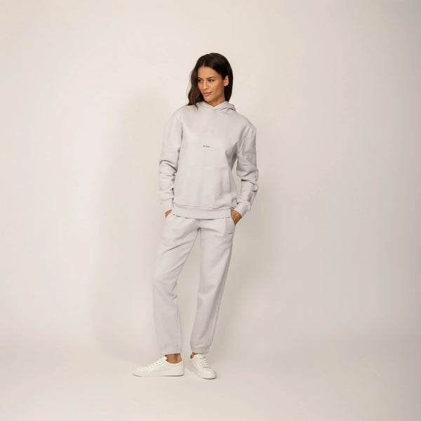 Woman wearing a Marame cotton fleece Logo Hoodie in Ash White, full view.|ash white