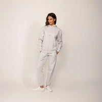 Woman wearing a Marame cotton fleece Logo Hoodie in Ash White, full view.|ash white