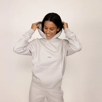 Woman wearing a Marame cotton fleece Logo Hoodie in Ash White, front view.|ash white