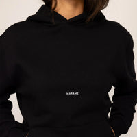 Woman wearing cotton fleece Logo Hoodie in Black, closeup.