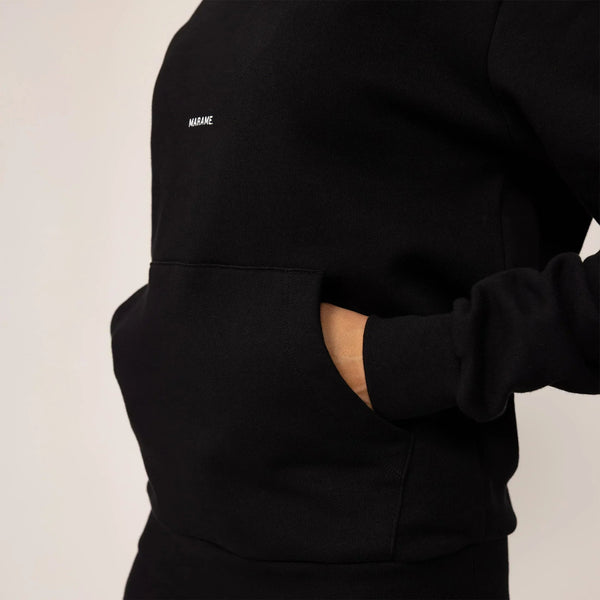 Woman wearing cotton fleece Logo Hoodie in Black, closeup.|black