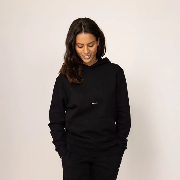 Woman wearing cotton fleece Logo Hoodie in Black, front view.|black