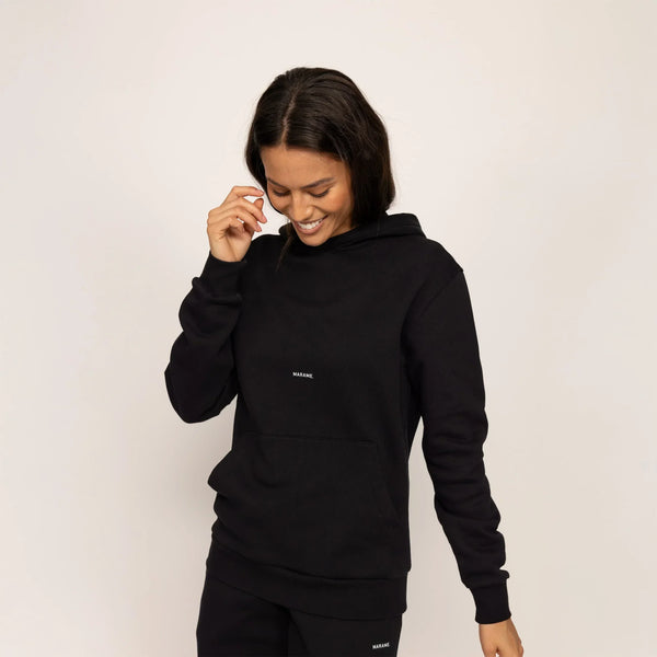 Woman wearing Marame cotton fleece Logo Hoodie in Black, front view.