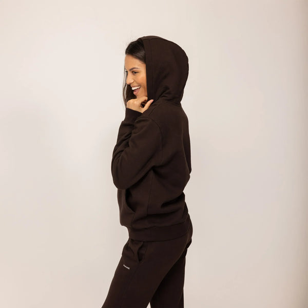 Woman wearing cotton fleece Logo Hoodie in Smoked Brown, side view.