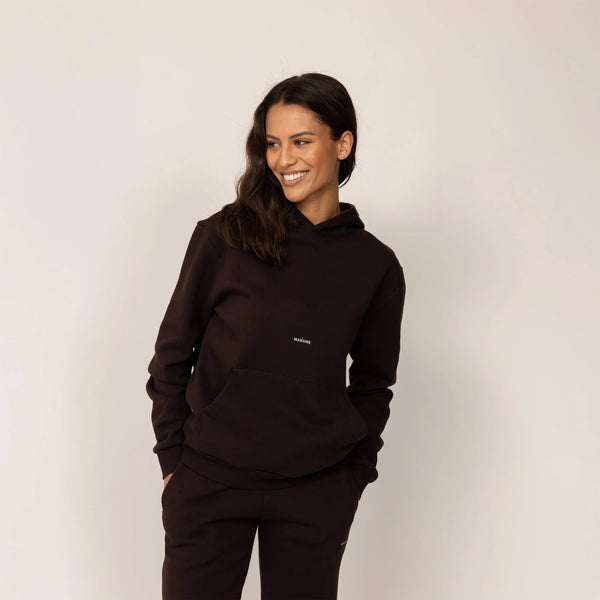 Woman wearing Marame cotton fleece Logo Hoodie in Smoked Brown, front view.