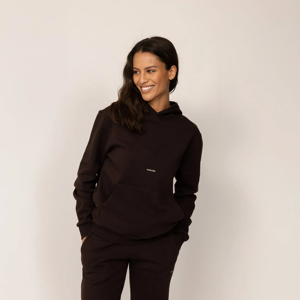 Woman wearing Marame cotton fleece Logo Hoodie in Smoked Brown, front view.
