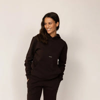 Woman wearing Marame cotton fleece Logo Hoodie in Smoked Brown, front view.