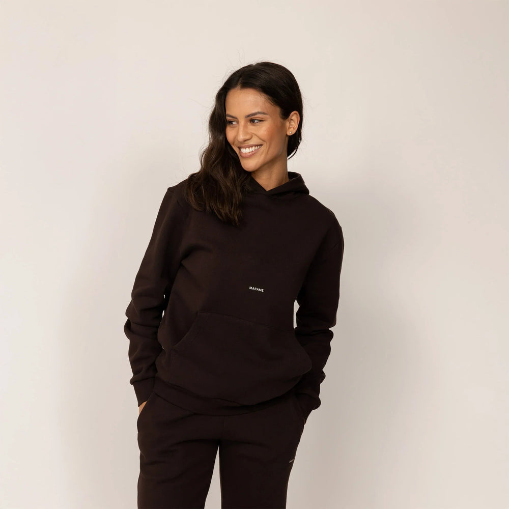 Woman wearing Marame cotton fleece Logo Hoodie in Smoked Brown, front view.|smoked brown