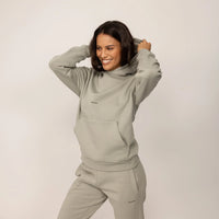 Woman wearing a Marame cotton fleece Logo Hoodie in Wolf Grey, front view.