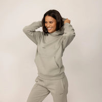 Woman wearing a Marame cotton fleece Logo Hoodie in Wolf Grey, front view.|wolf green