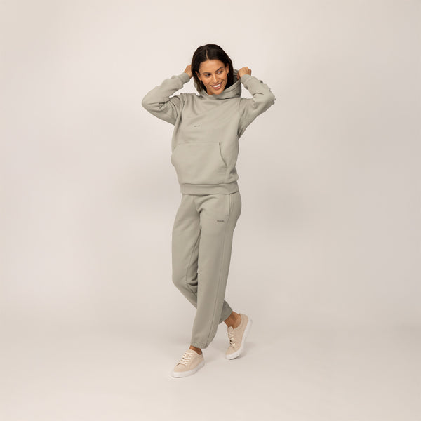 Woman wearing a Marame cotton fleece Logo Hoodie in Wolf Grey, full view.