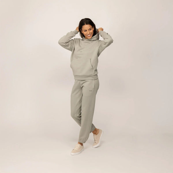 Woman wearing a Marame cotton fleece Logo Hoodie in Wolf Grey, full view.|wolf green