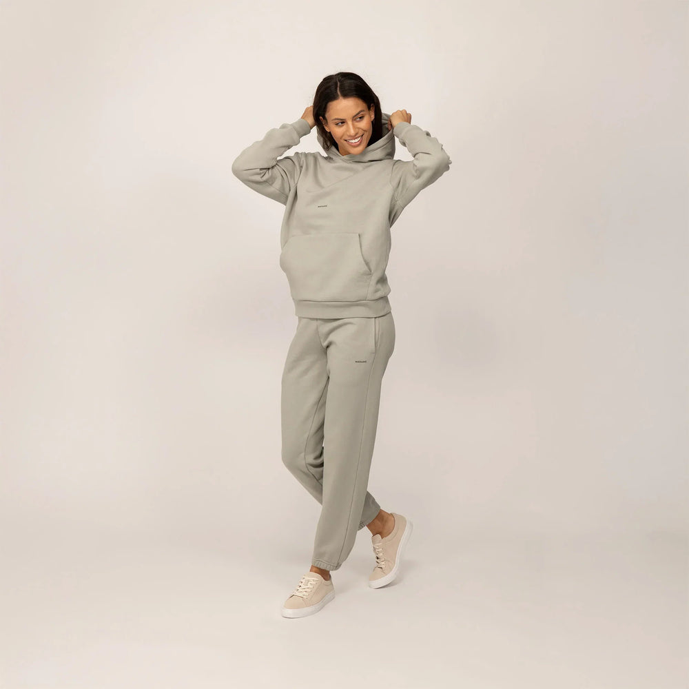 Woman wearing a Marame cotton fleece Logo Hoodie in Wolf Grey, full view.|wolf green