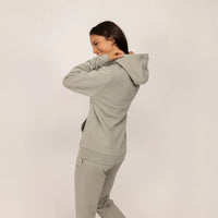 Woman wearing a cotton fleece Logo Hoodie in Wolf Grey, rear view.