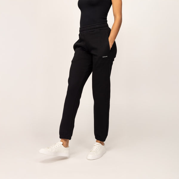 Woman wearing cotton fleece Joggers in Black, front view.