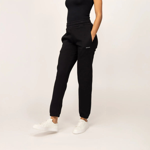 Woman wearing cotton fleece Joggers in Black, front view.|black
