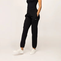 Woman wearing cotton fleece Joggers in Black, front view.|black
