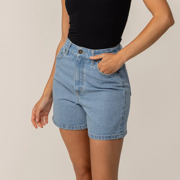 Woman wearing Marame Denim Shorts in Light Wash Denim, front view.