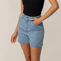 Woman wearing Marame Denim Shorts in Light Wash Denim, front view.